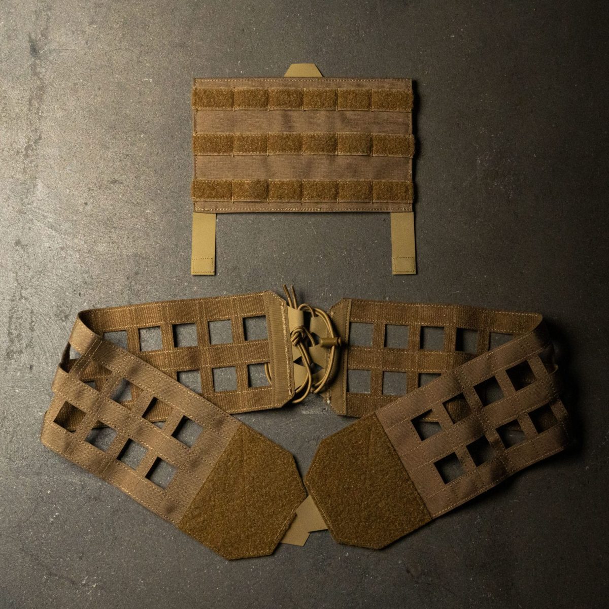 A coyote brown MOLLE cummerbund with a quick-release system, designed for plate carriers, featuring laser-cut MOLLE webbing, secure lacing, and Velcro panels for modular customization and rapid deployment.