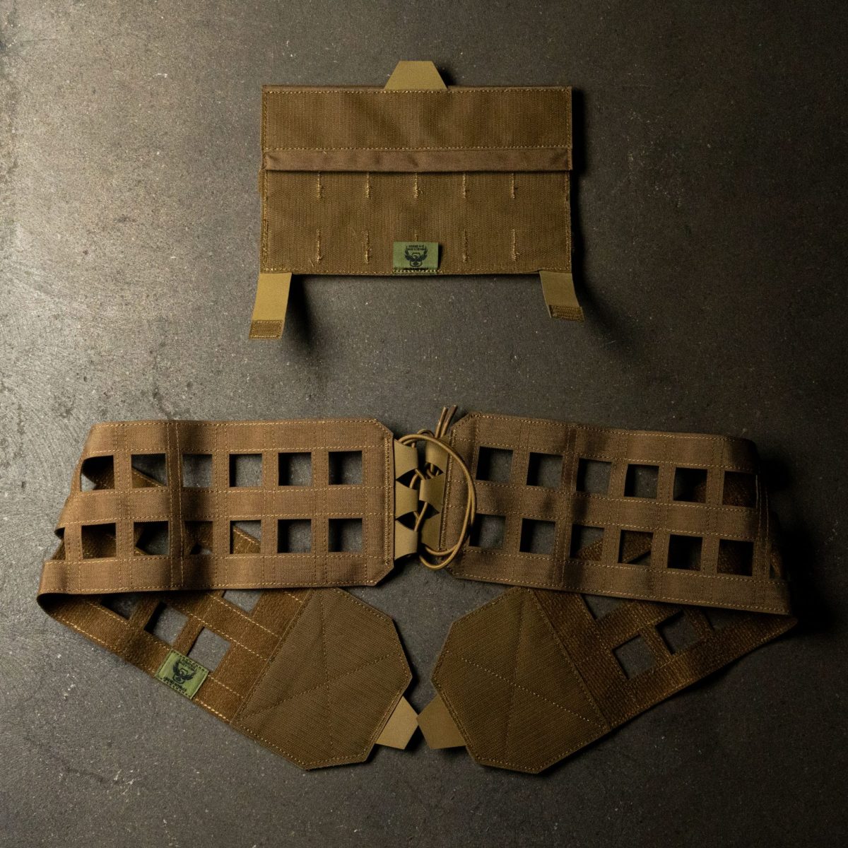 A coyote brown MOLLE cummerbund with a quick-release system, designed for plate carriers, featuring laser-cut MOLLE webbing, secure lacing, and Velcro panels for modular customization and rapid deployment.
