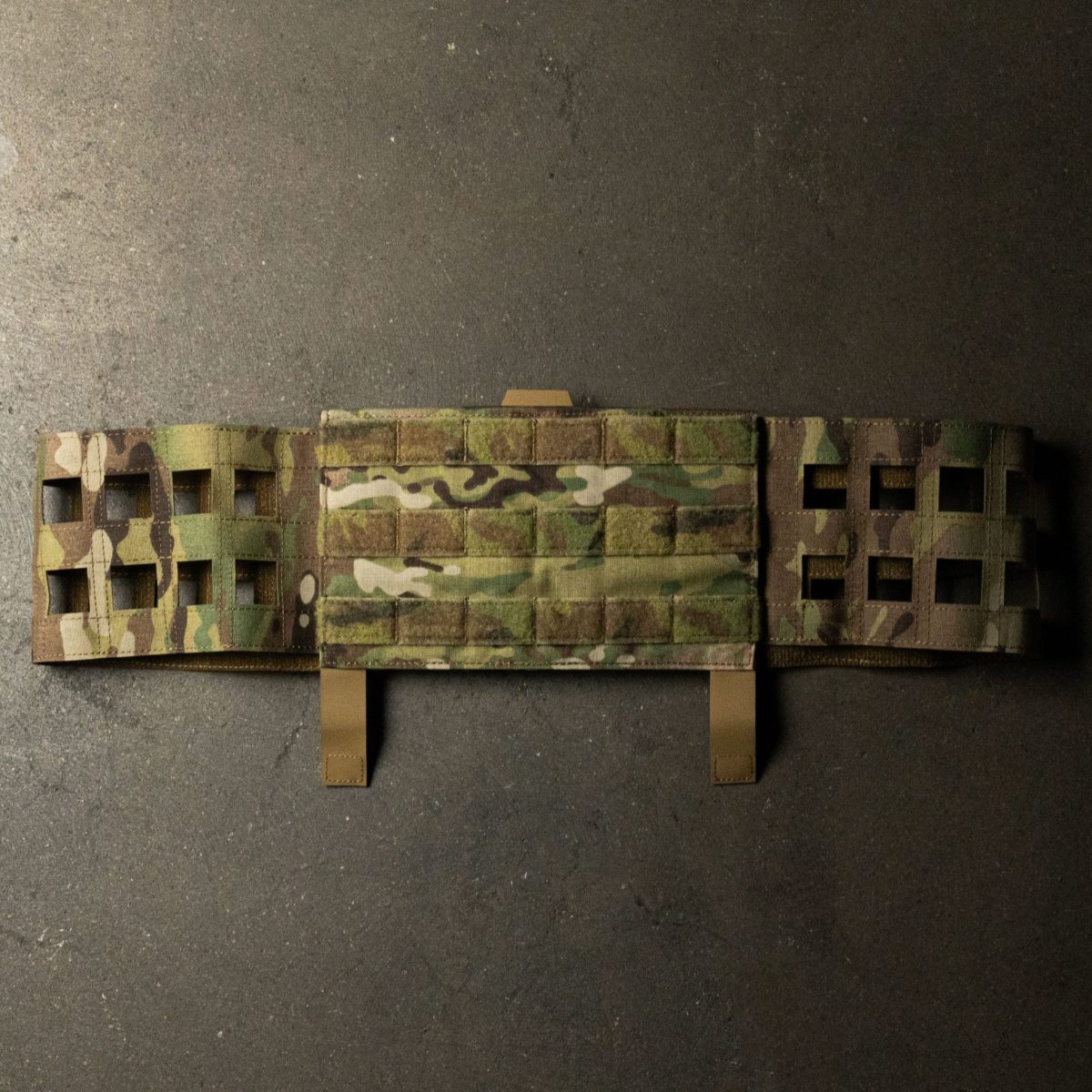 A Multicam MOLLE cummerbund, designed for plate carriers, featuring laser-cut MOLLE webbing and Velcro panels for secure attachment and modular loadout customization.