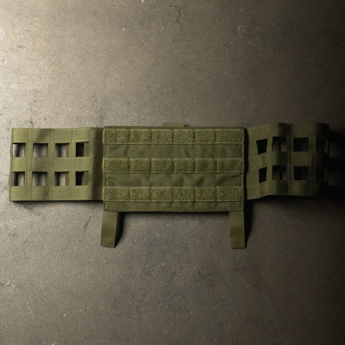 A military-grade olive drab MOLLE cummerbund, designed for plate carriers, featuring laser-cut MOLLE webbing and Velcro panels for modular loadout customization.